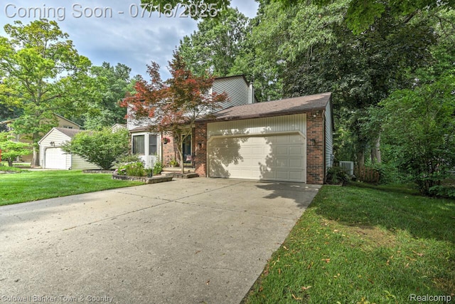 978 Oak Ridge Cir, Brighton, MI 48116 - view of front facade featuring brick siding, a front lawn, a garage, and driveway