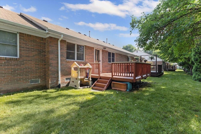 22830 Lincoln Ct, Saint Clair Shores, MI 48082 - rear view of house featuring brick siding, a yard, a wooden deck, and roof with shingles