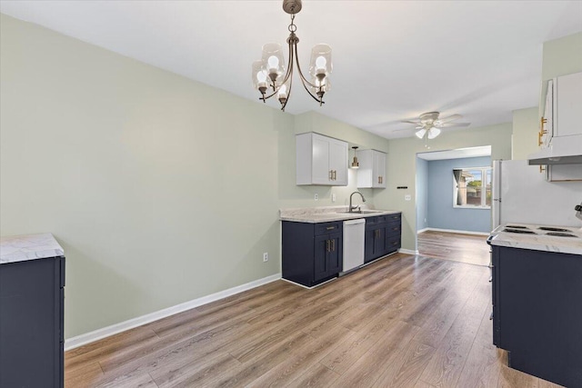 22830 Lincoln Ct, Saint Clair Shores, MI 48082 - kitchen featuring a ceiling fan, white appliances, light wood finished floors, a chandelier, and hanging light fixtures