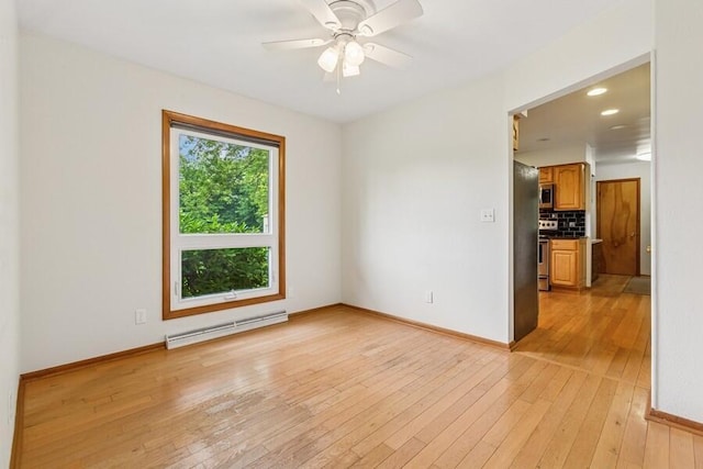 13613 Log Cabin Rd, Three Oaks, MI 49128 - unfurnished room with a baseboard radiator, light wood-type flooring, and ceiling fan