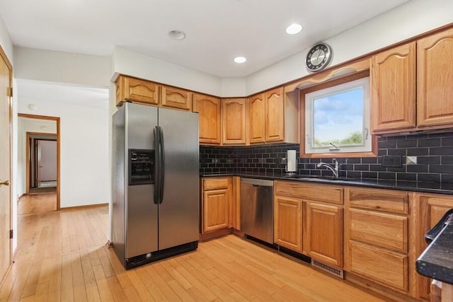 13613 Log Cabin Rd, Three Oaks, MI 49128 - kitchen featuring appliances with stainless steel finishes, brown cabinets, decorative backsplash, light wood-style floors, and recessed lighting