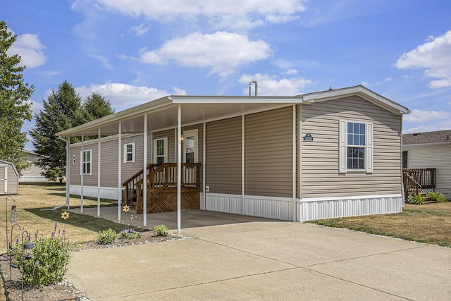 13750 Primrose Ln, Cedar Springs, MI 49319 - manufactured / mobile home with concrete driveway and a carport