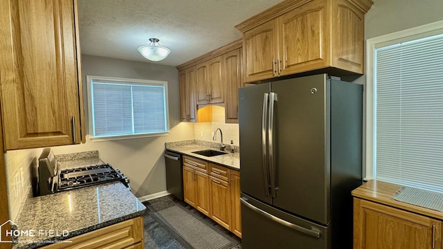 510 Martin St, Owosso, MI 48867 - kitchen featuring freestanding refrigerator, dishwasher, gas stove, backsplash, and stone countertops