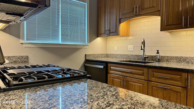 510 Martin St, Owosso, MI 48867 - kitchen with ventilation hood, decorative backsplash, dark stone countertops, and dishwashing machine