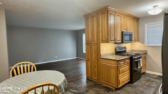 510 Martin St, Owosso, MI 48867 - kitchen with appliances with stainless steel finishes, a textured ceiling, and backsplash