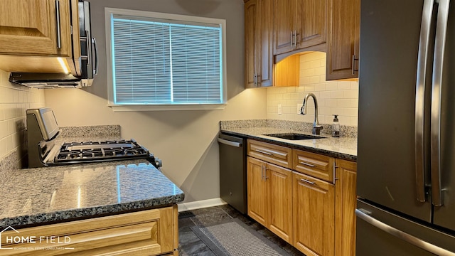 510 Martin St, Owosso, MI 48867 - kitchen with appliances with stainless steel finishes, decorative backsplash, and dark stone counters