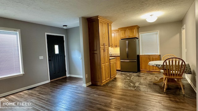 510 Martin St, Owosso, MI 48867 - kitchen with freestanding refrigerator, dark wood finished floors, light countertops, a textured ceiling, and brown cabinetry