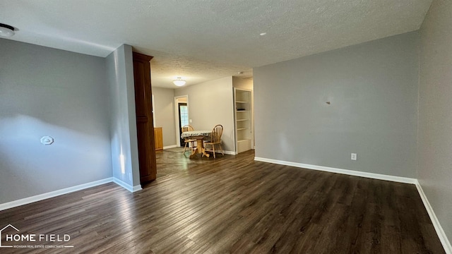 510 Martin St, Owosso, MI 48867 - empty room with a textured ceiling and dark wood finished floors