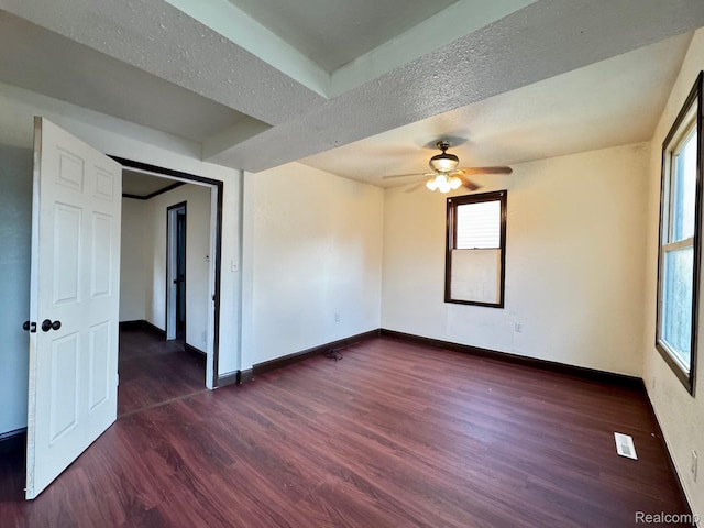 1128 White St, Port Huron, MI 48060 - spare room featuring dark wood-style floors, a ceiling fan, healthy amount of natural light, and a textured ceiling
