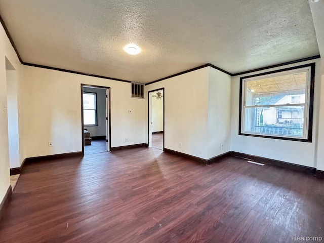 1128 White St, Port Huron, MI 48060 - empty room with a textured ceiling, dark wood-style flooring, and crown molding