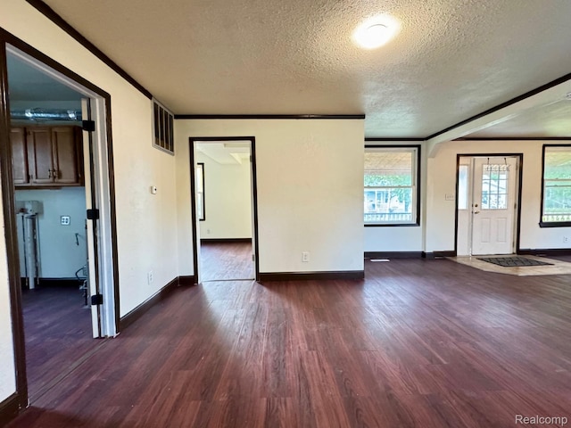 1128 White St, Port Huron, MI 48060 - spare room featuring dark wood-style floors, a textured ceiling, and ornamental molding