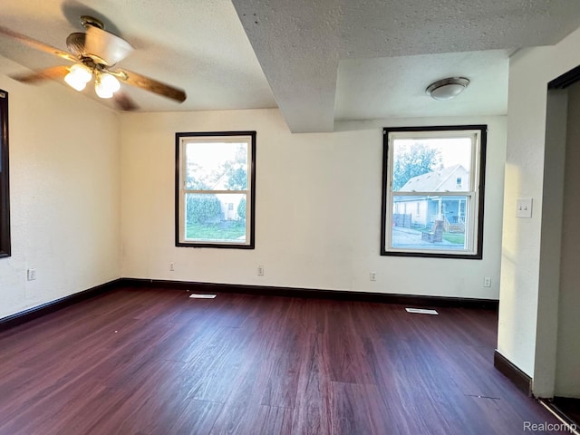 1128 White St, Port Huron, MI 48060 - unfurnished room with dark wood-style floors, healthy amount of natural light, a textured ceiling, and a ceiling fan