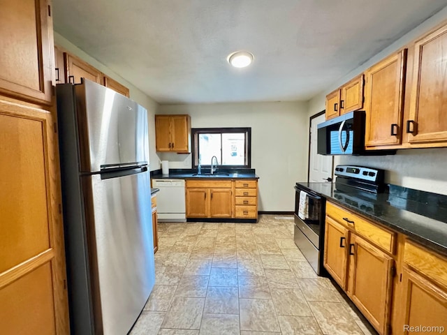 1128 White St, Port Huron, MI 48060 - kitchen with appliances with stainless steel finishes and dark stone counters