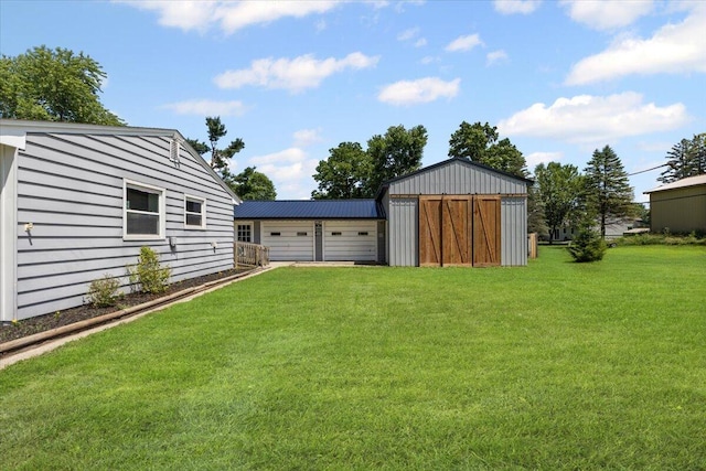 10965 Bunton Rd, Willis, MI 48191 - view of grassy yard with an outdoor structure and a garage