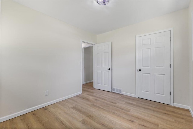 10965 Bunton Rd, Willis, MI 48191 - unfurnished bedroom with light wood finished floors