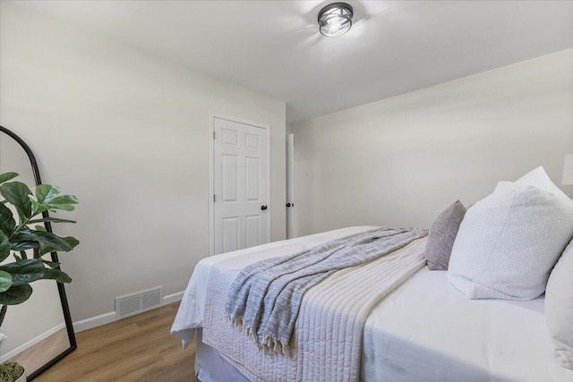 10965 Bunton Rd, Willis, MI 48191 - bedroom featuring baseboards and wood finished floors