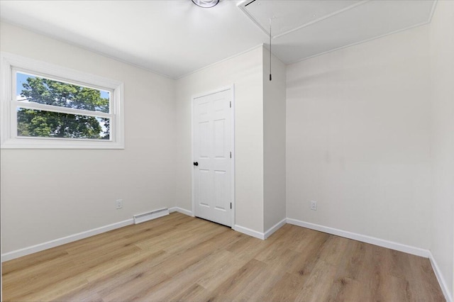 10965 Bunton Rd, Willis, MI 48191 - unfurnished bedroom featuring attic access and light wood finished floors