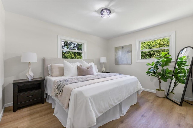 10965 Bunton Rd, Willis, MI 48191 - bedroom featuring multiple windows and light wood-style floors