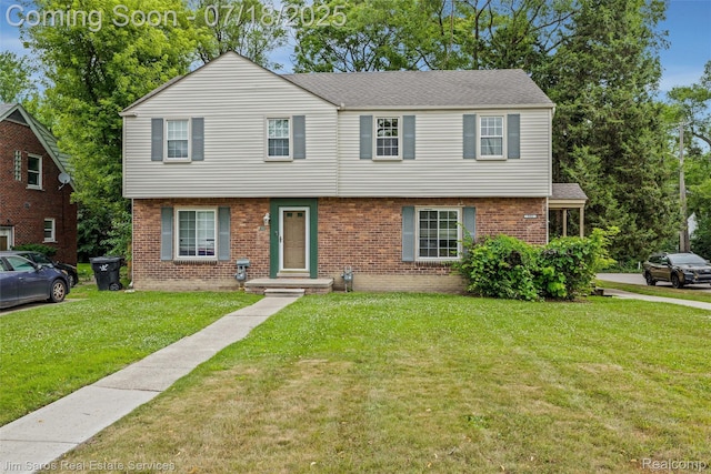 302 Alter Rd, Detroit, MI 48215 - colonial house featuring a front yard, brick siding, and roof with shingles