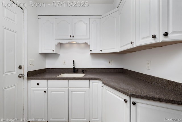 302 Alter Rd, Detroit, MI 48215 - kitchen featuring dark countertops and white cabinets