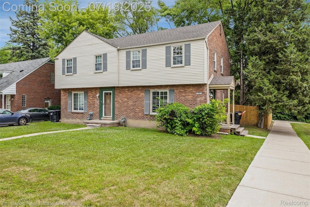 302 Alter Rd, Detroit, MI 48215 - colonial house with brick siding, a front lawn, and a shingled roof