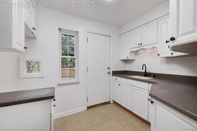 302 Alter Rd, Detroit, MI 48215 - kitchen with dark countertops, white cabinetry, and light floors