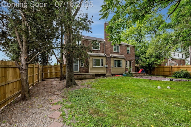 302 Alter Rd, Detroit, MI 48215 - back of house with a fenced backyard, brick siding, and a chimney