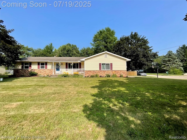5363 Irish Rd, Grand Blanc, MI 48439 - single story home featuring a porch, a front yard, and brick siding