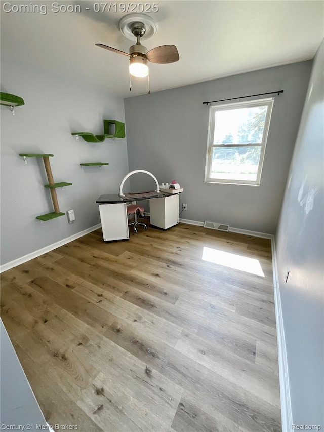 5363 Irish Rd, Grand Blanc, MI 48439 - spare room with wood finished floors, a ceiling fan, and a desk