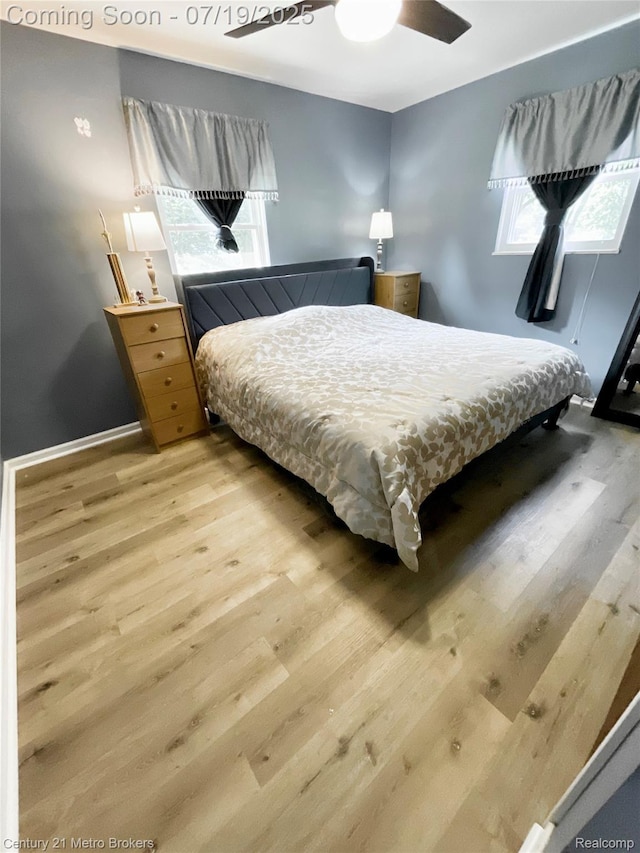 5363 Irish Rd, Grand Blanc, MI 48439 - bedroom featuring light wood finished floors, multiple windows, and a ceiling fan