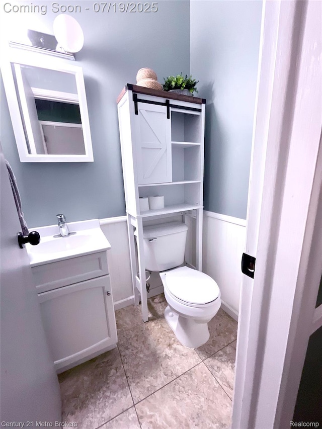 5363 Irish Rd, Grand Blanc, MI 48439 - bathroom with vanity, tile patterned floors, and wainscoting