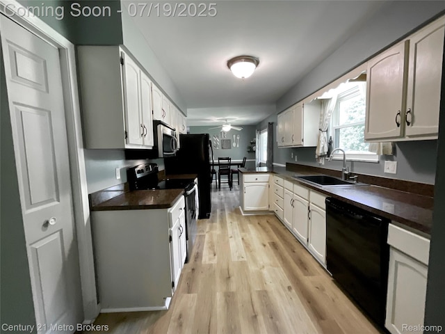 5363 Irish Rd, Grand Blanc, MI 48439 - kitchen with appliances with stainless steel finishes, dark countertops, light wood-style floors, and a peninsula