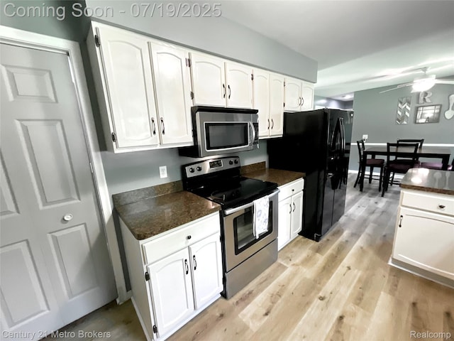 5363 Irish Rd, Grand Blanc, MI 48439 - kitchen with dark countertops, stainless steel appliances, white cabinetry, and a ceiling fan