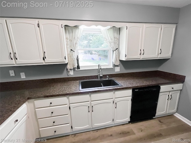 5363 Irish Rd, Grand Blanc, MI 48439 - kitchen with dark countertops, white cabinetry, black dishwasher, and light wood-style flooring