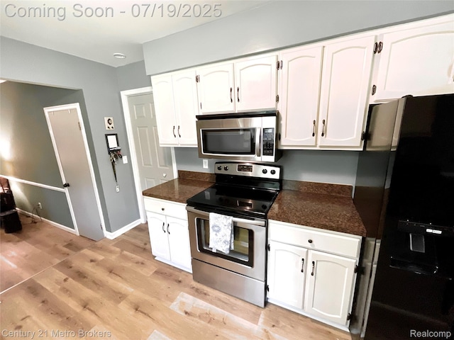 5363 Irish Rd, Grand Blanc, MI 48439 - kitchen with appliances with stainless steel finishes, white cabinetry, and light wood finished floors