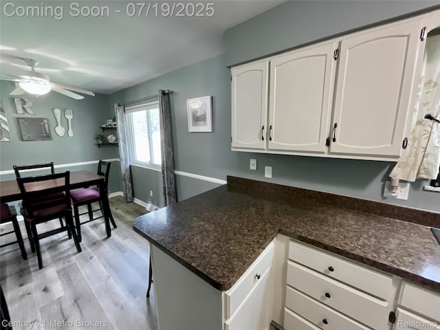 5363 Irish Rd, Grand Blanc, MI 48439 - kitchen with white cabinets, light wood-type flooring, a ceiling fan, and a peninsula