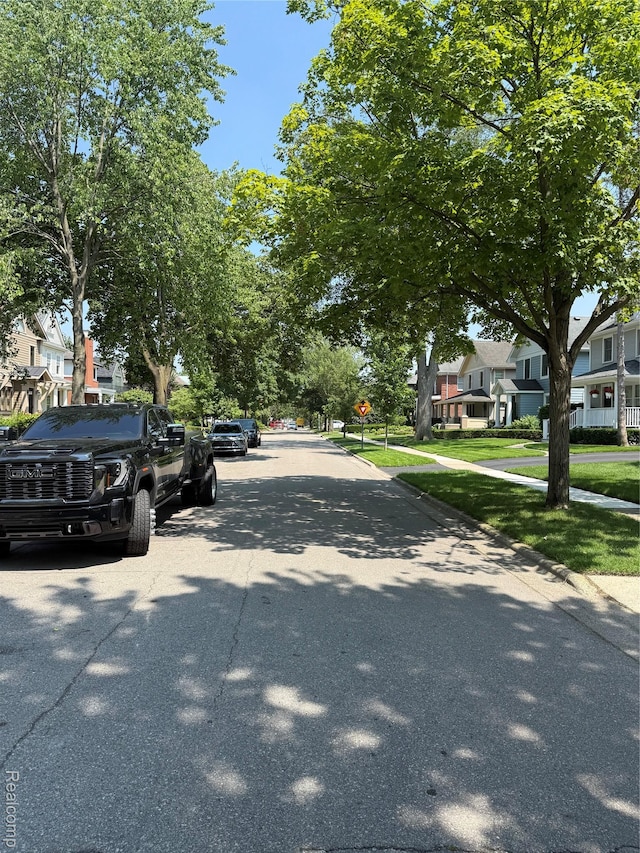 730 Wallace St, Birmingham, MI 48009 - view of asphalt road featuring a residential view, sidewalks, curbs, and traffic signs