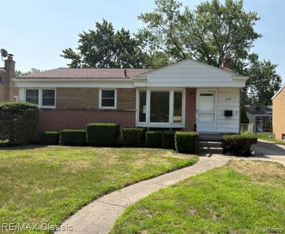 242 E Parker Ave, Madison Heights, MI 48071 - view of front of home with brick siding and a front yard