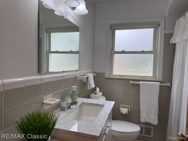 242 E Parker Ave, Madison Heights, MI 48071 - bathroom featuring vanity, tile walls, wainscoting, and a shower with curtain