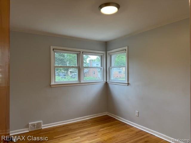 242 E Parker Ave, Madison Heights, MI 48071 - spare room with light wood-style flooring and ornamental molding