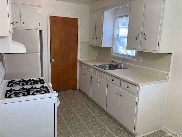 24924 Wilmot Ave, Eastpointe, MI 48021 - kitchen with white gas range, fridge, light countertops, and white cabinetry