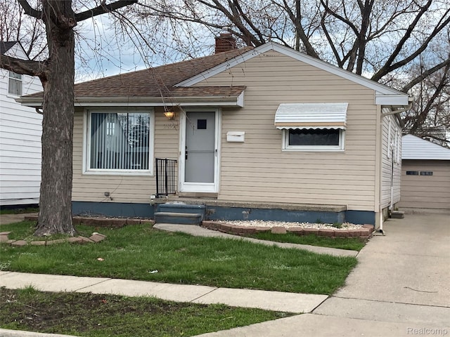 24924 Wilmot Ave, Eastpointe, MI 48021 - bungalow featuring a chimney, an outdoor structure, and roof with shingles