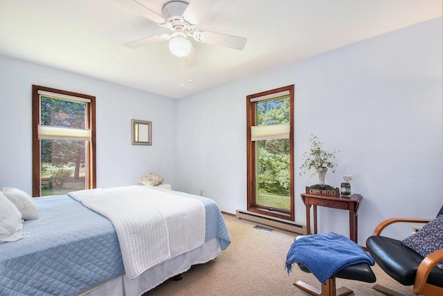 18354 Mount Zion Rd, Galien, MI 49113 - bedroom featuring multiple windows, baseboard heating, light carpet, and a ceiling fan