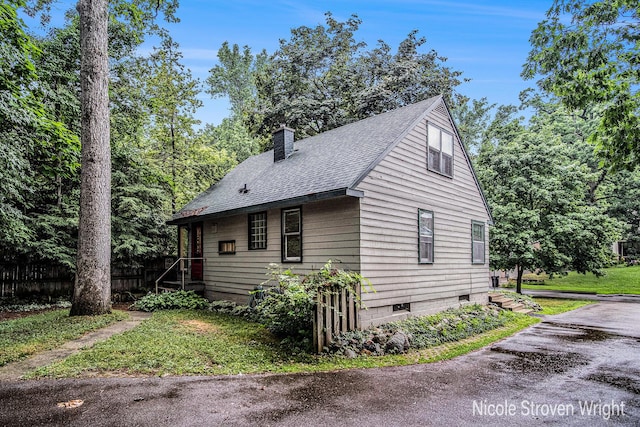 2146 Lansing St SE, Grand Rapids, MI 49506 - view of side of home with a chimney and a shingled roof