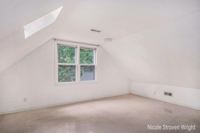 2146 Lansing St SE, Grand Rapids, MI 49506 - additional living space featuring a skylight, lofted ceiling, and wood finished floors