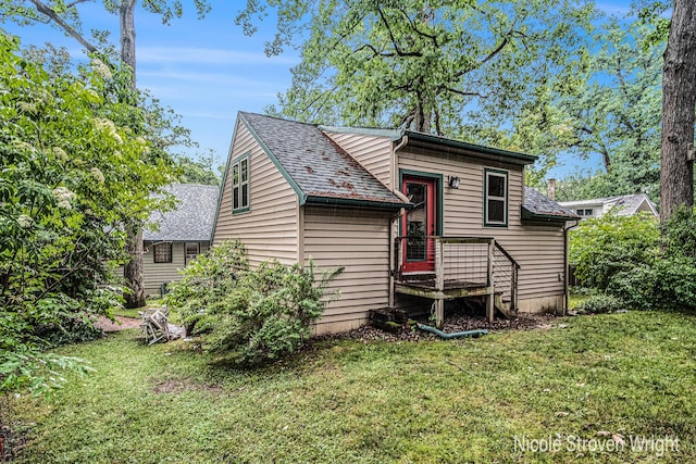 2146 Lansing St SE, Grand Rapids, MI 49506 - view of side of property with a lawn and roof with shingles