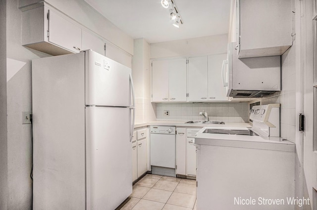 2146 Lansing St SE, Grand Rapids, MI 49506 - kitchen featuring white appliances, light tile patterned flooring, light countertops, white cabinets, and backsplash