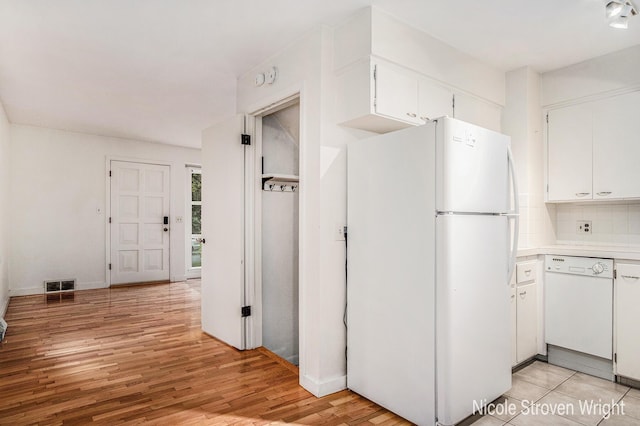 2146 Lansing St SE, Grand Rapids, MI 49506 - kitchen with white appliances, white cabinetry, light countertops, and light wood-type flooring