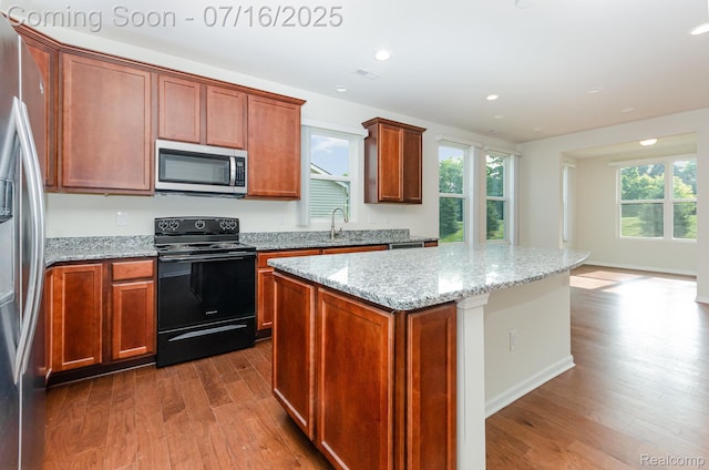 4000 Ashdale Way, Clarkston, MI 48348 - kitchen with stainless steel appliances, dark wood-type flooring, a kitchen island, light stone counters, and recessed lighting