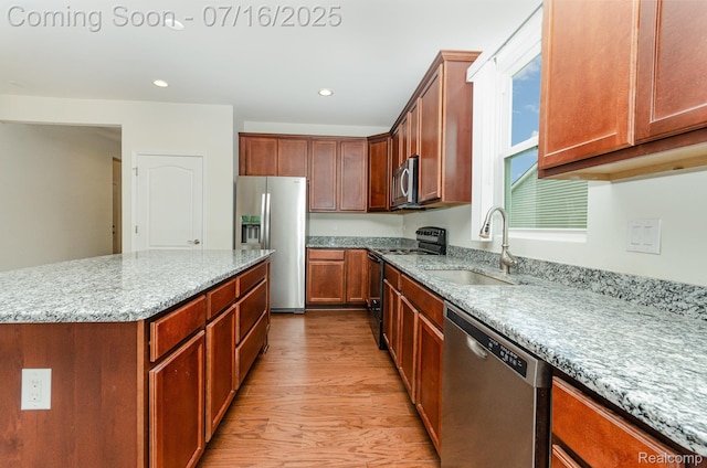 4000 Ashdale Way, Clarkston, MI 48348 - kitchen featuring light wood-style flooring, appliances with stainless steel finishes, light stone countertops, recessed lighting, and a kitchen island